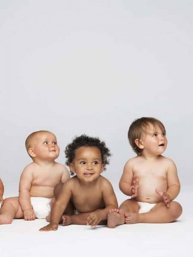 Row,Of,Multiethnic,Babies,Sitting,Side,By,Side,Looking,Away