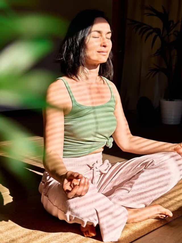 Woman,Practicing,Yoga,And,Meditation,At,Home,Sitting,In,Lotus