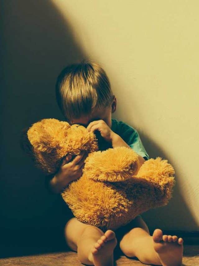 Lonely,Scared,Boy,Sitting,In,Corner,,Hugging,His,Teddy,Bear