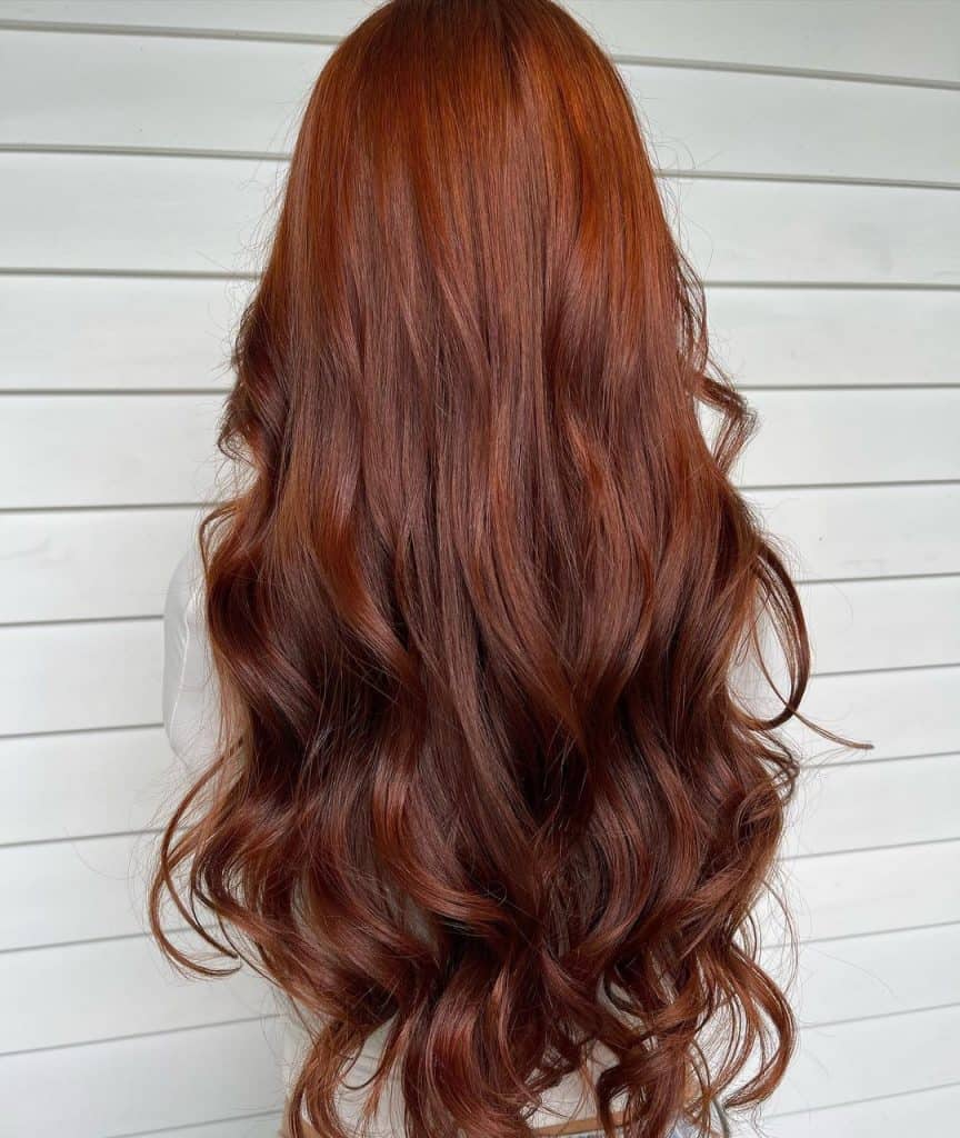  Long, wavy red hair cascading down the woman's back.