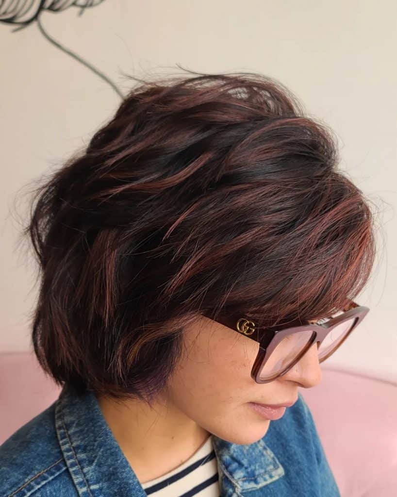  A lady wearing glasses and a short bob haircut in the picture.