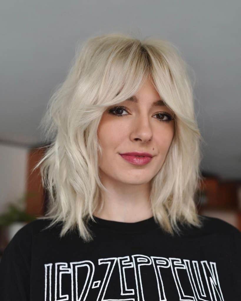Woman with blonde bob in black Led Zeppelin shirt.