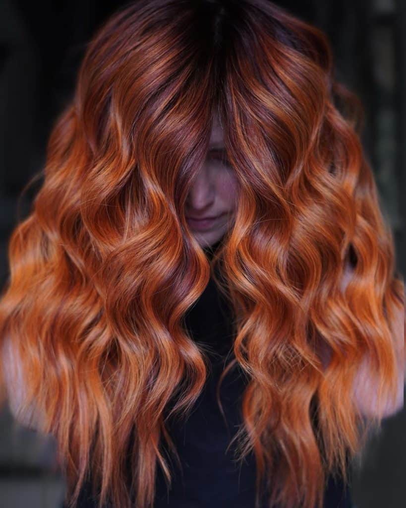 A woman with long red and orange hair.