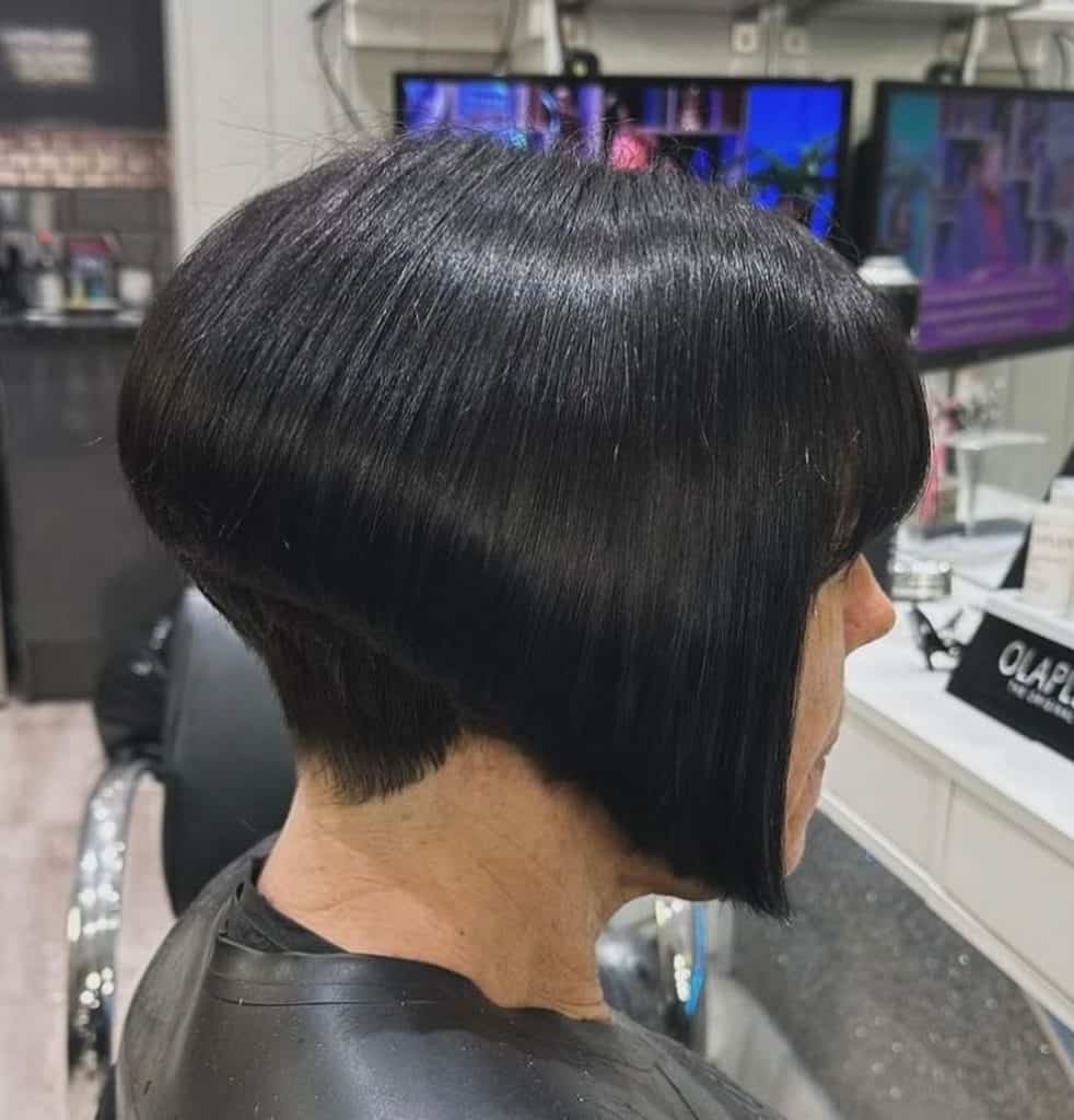 A woman with a short black bob haircut, looking stylish and confident.