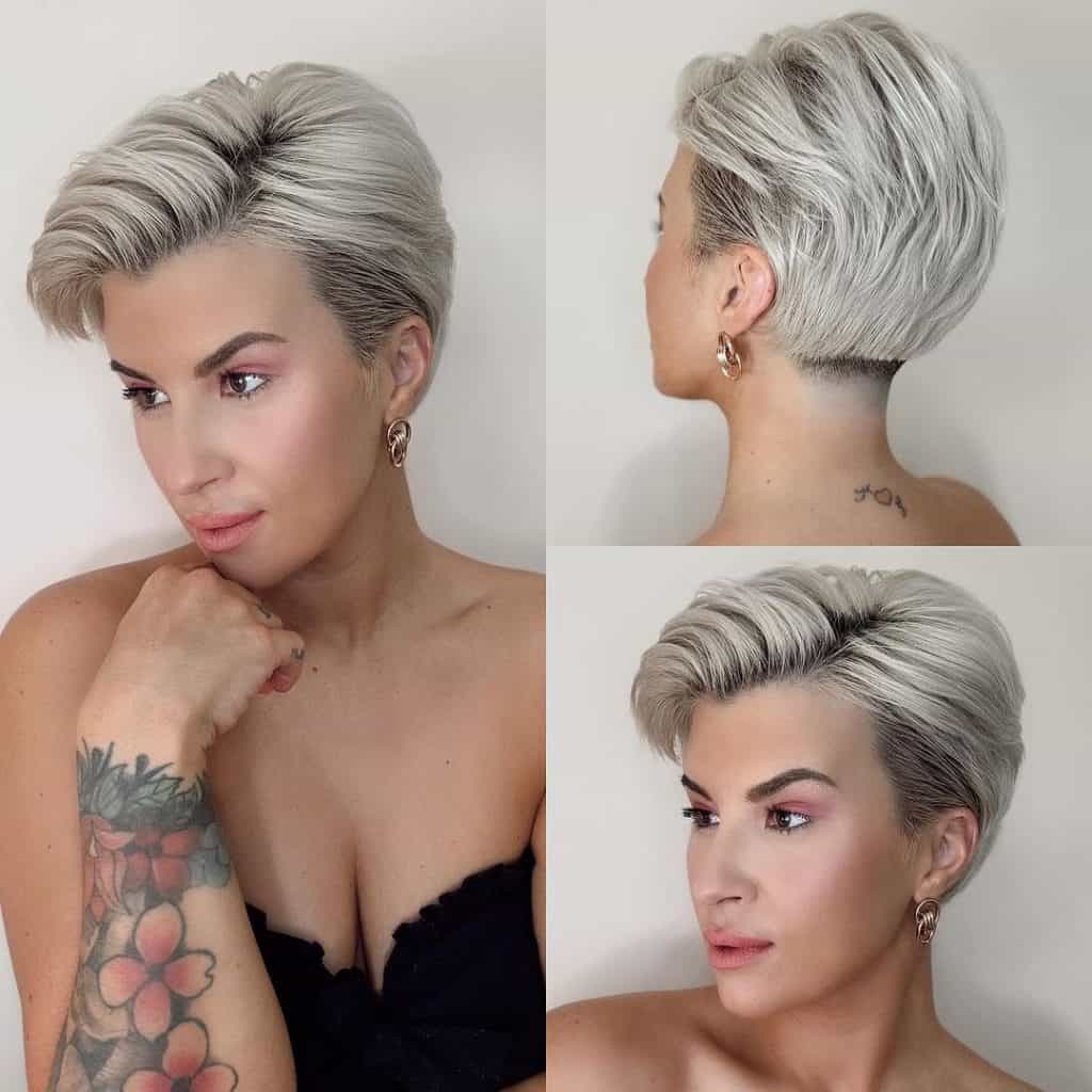 A woman with short blonde hair and tattoos.