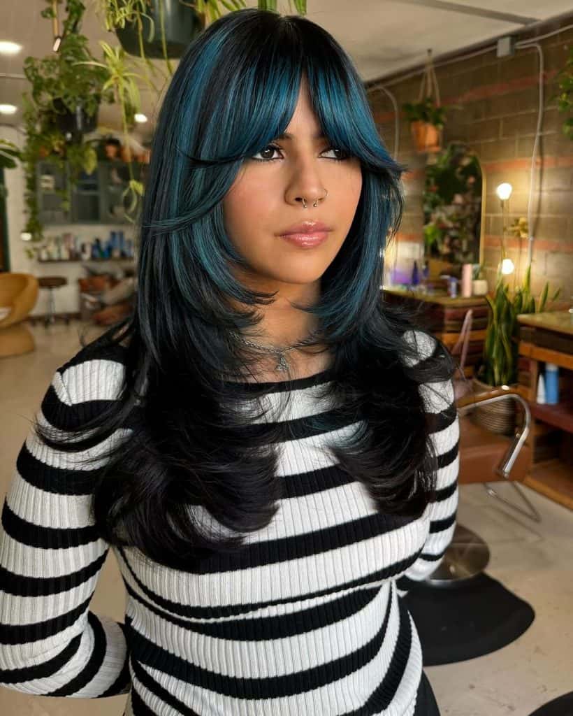 A woman with a vibrant blue and black hair style, showcasing a unique and bold look.