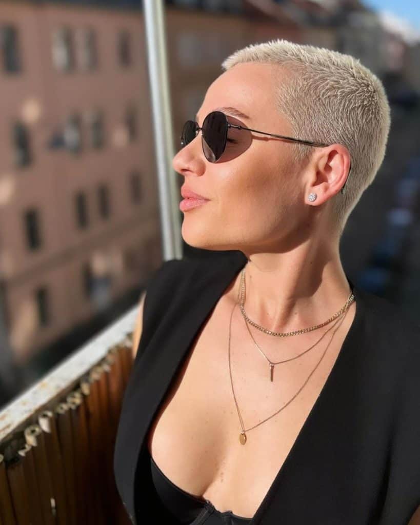 A stylish woman with short hair and sunglasses.