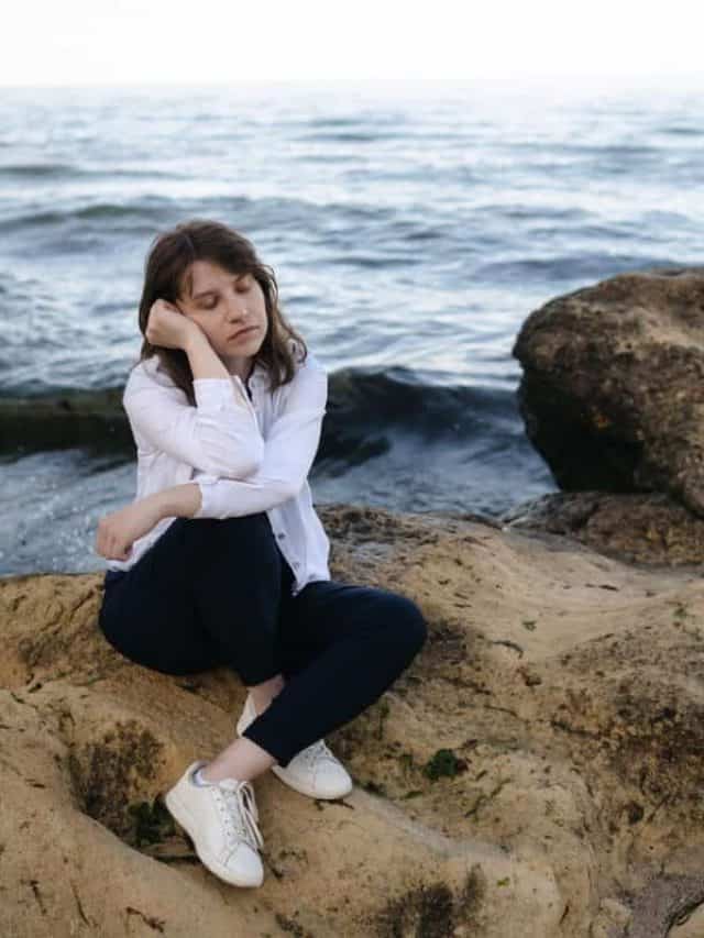 Sadly,Depressed,Woman,Sitting,On,Rock,At,The,Sea.,Bad