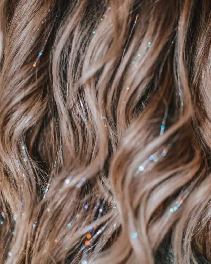 “ Add a touch of sparkle to your look with our new hair tinsel service! Shine bright this season. #hairtinsel #sparklehair #newservice