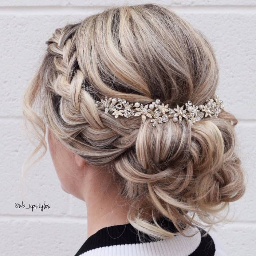 Side french braid loosened into a textured low bun! • • Tip When loosening braids, d