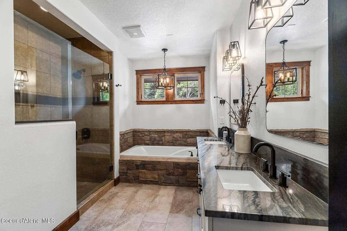 Primary bathroom with a dual sink vanity, a bathtub, and a walk-in shower.