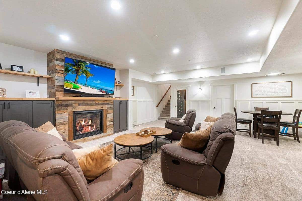 Family room with brown chairs, nesting coffee tables, and a fireplace flanked by base cabinets.