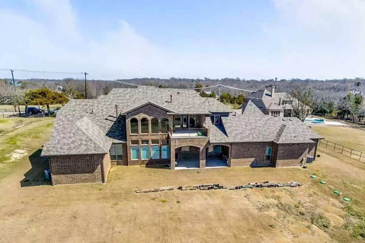 Rear view with huge windows and covered porches.