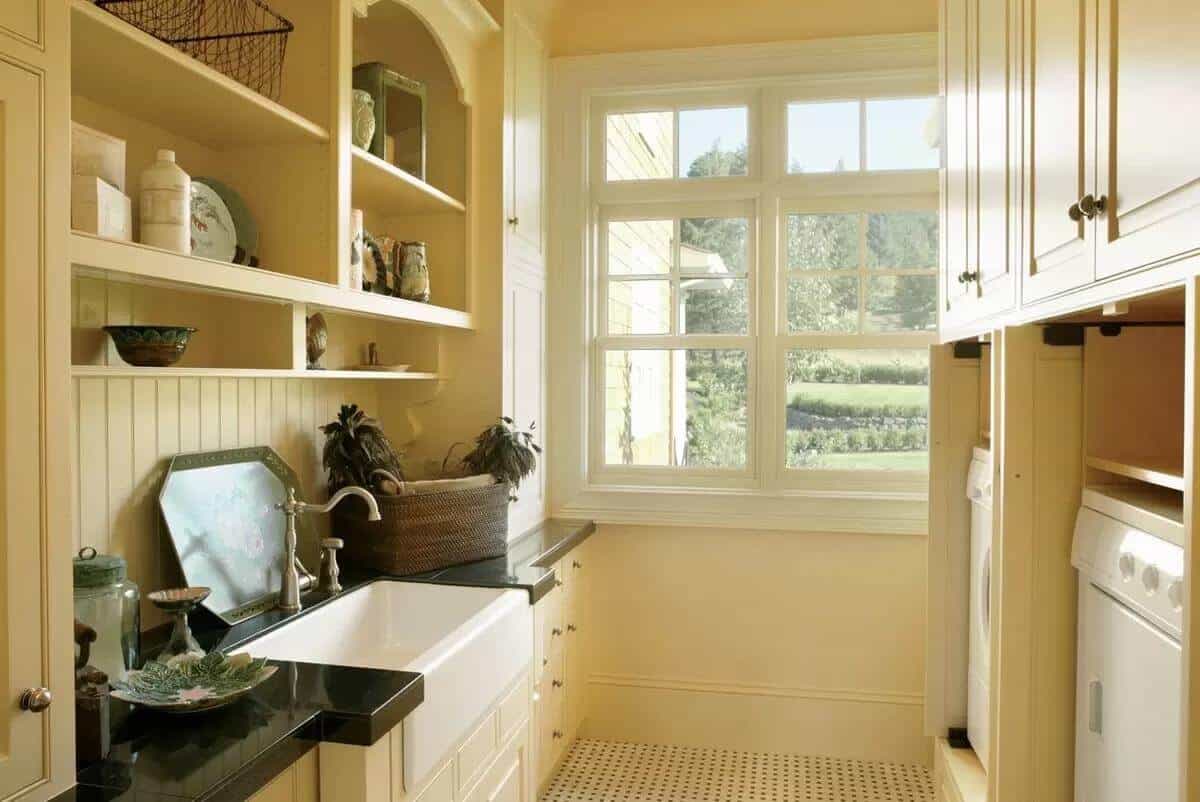 Laundry room with built-in cabinets and a utility sink.