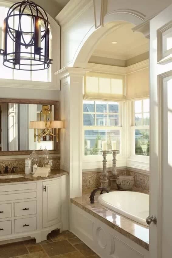 Primary bathroom with a white vanity and a bathtub.