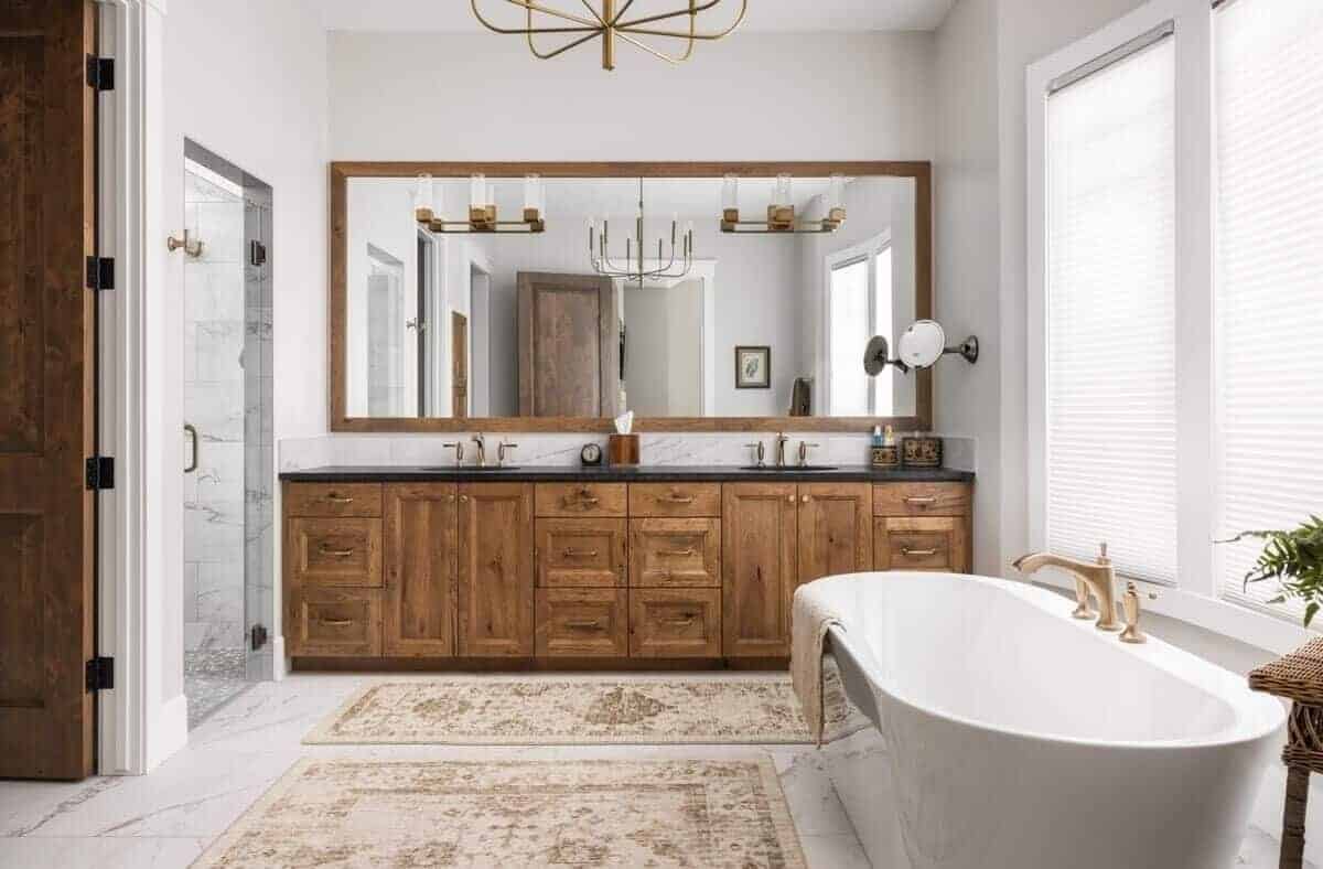 Primary bathroom with a soaking tub, a dual sink vanity, and a tiled shower.