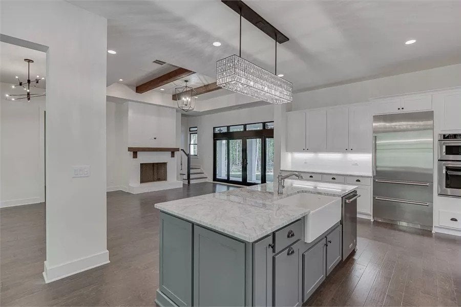 Kitchen island with a farmhouse sink overlooking the great room.