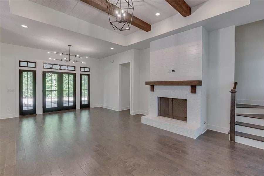 Great room with hardwood flooring and a brick fireplace.