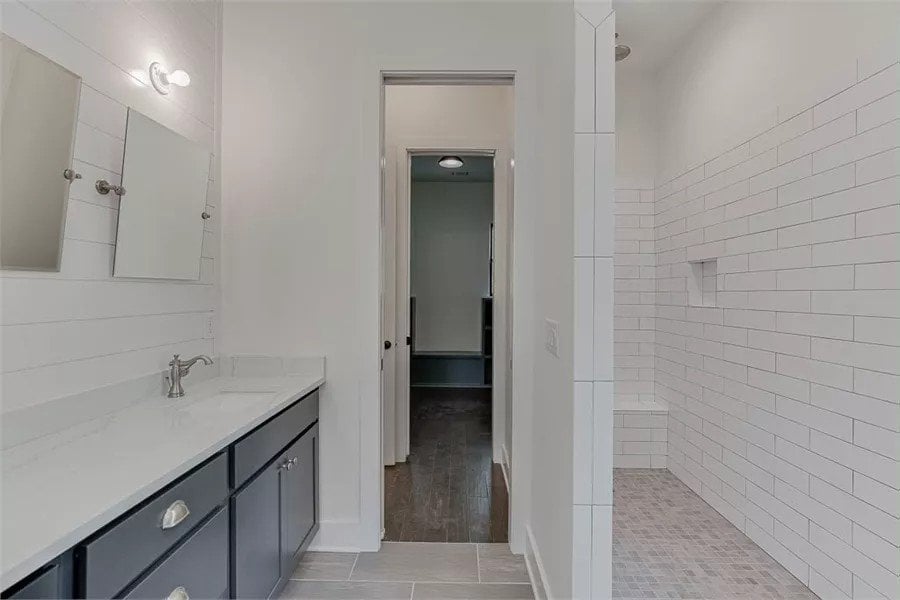 The primary bathroom includes a walk-in shower with a tiled bench.