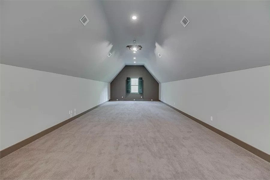 Bonus room with a carpeted floor and a coved ceiling.