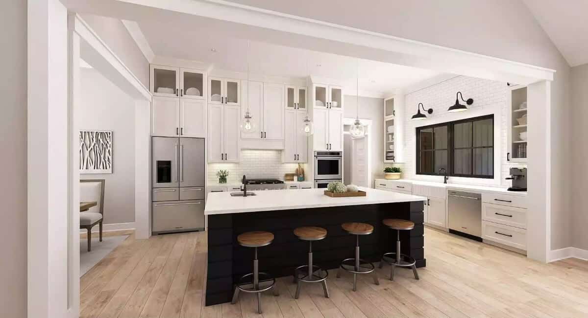 Kitchen with white cabinets, high-end appliances, and a breakfast island.