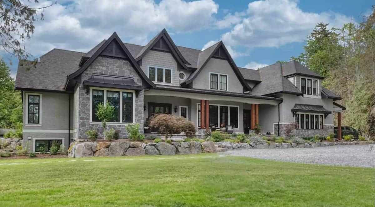 Front view with gale rooflines and a covered entry porch lined with double columns.