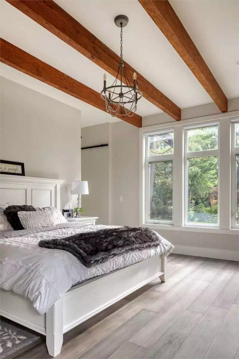 A beamed ceiling crowns the primary bedroom.