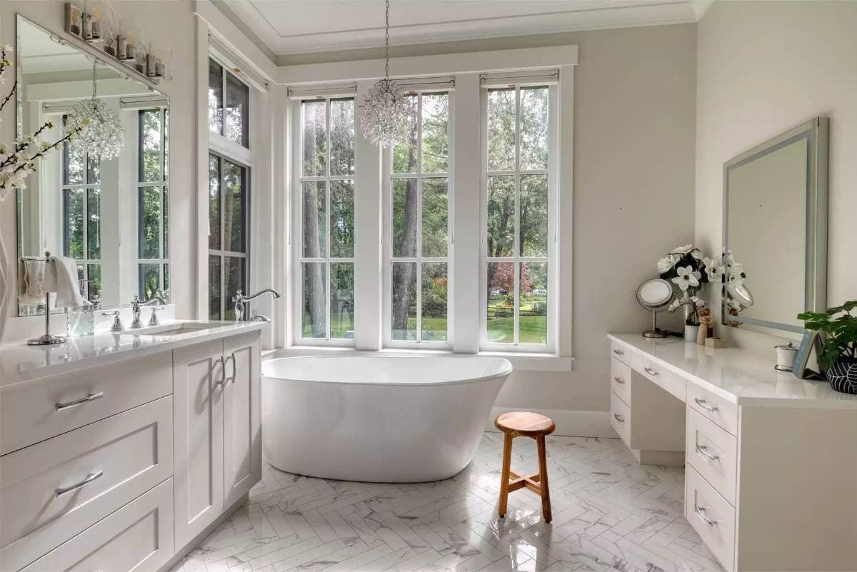 Primary bathroom with a dual sink vanity, a soaking tub, and a separate makeup counter.