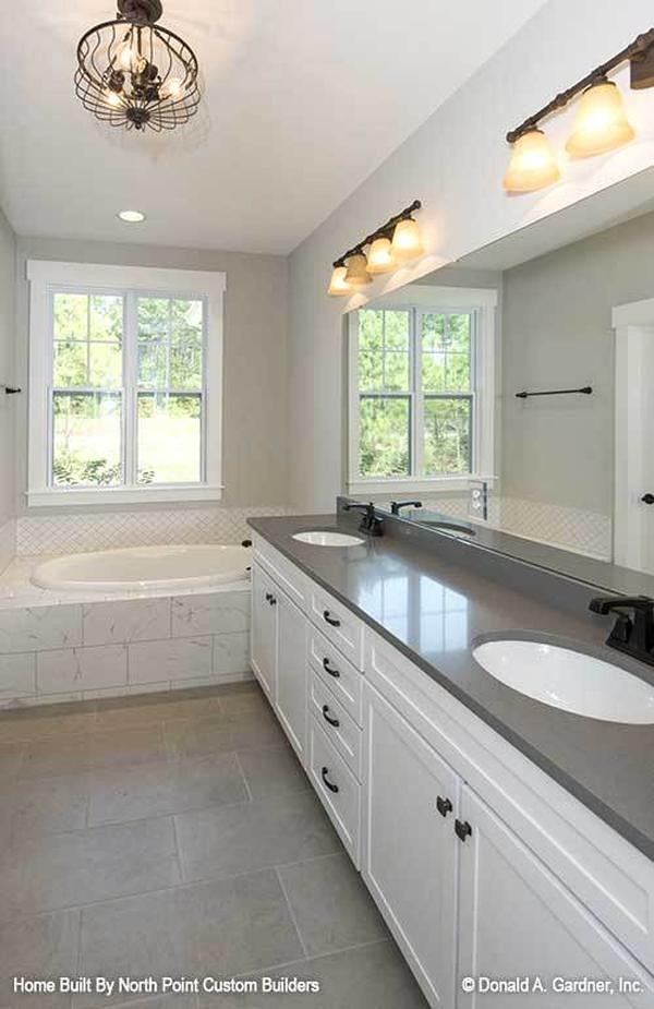 Two-tier peninsula fitted with a double bowl sink complete the kitchen.