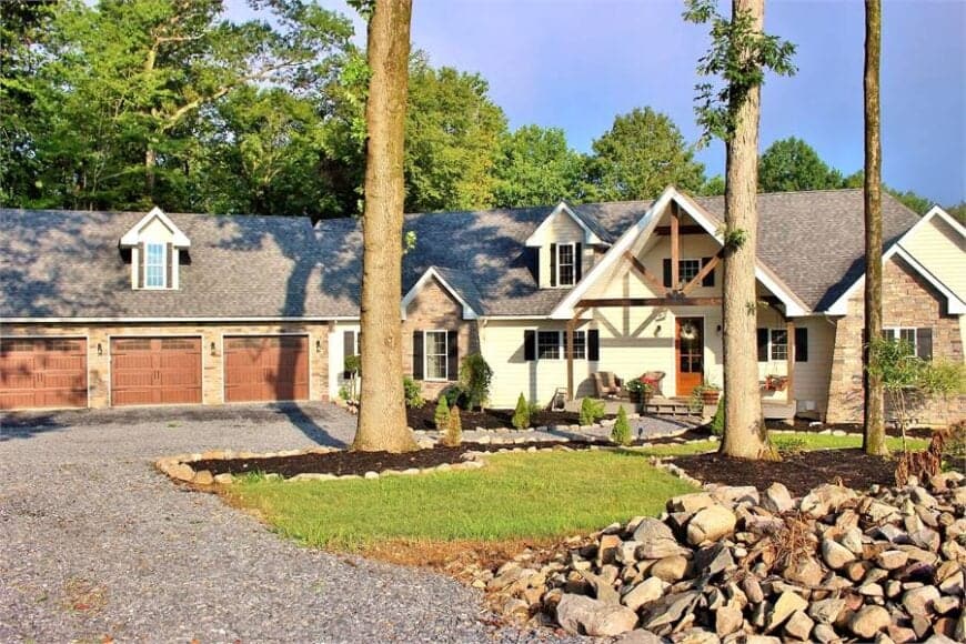 Towering trees along with a serene landscaping complement the single-story home graced with an angled garage.