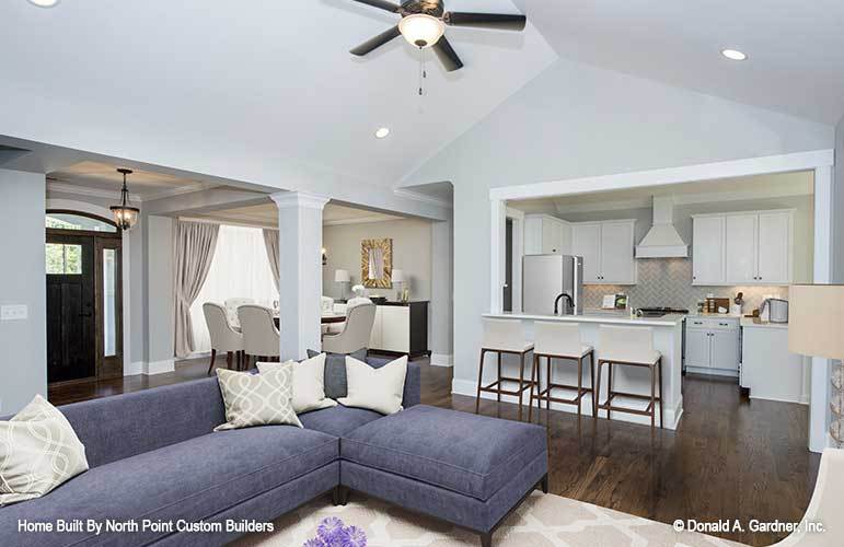 An open layout view showing the living area, kitchen, dining room, and the foyer.