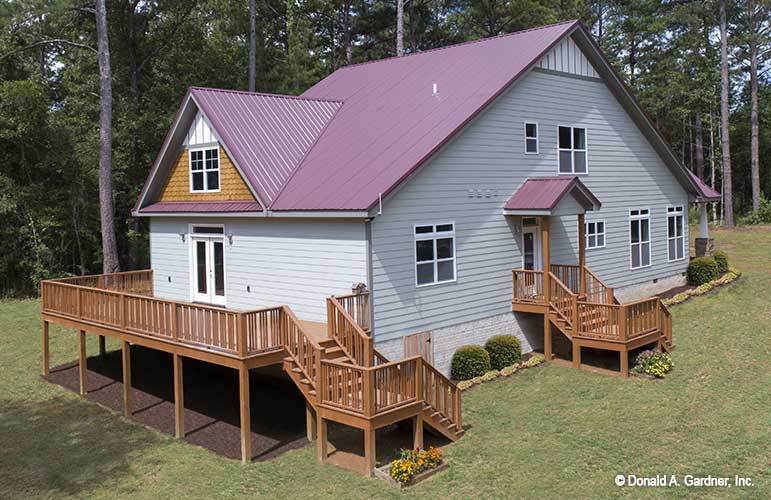 Angled rear view showing the back and expansive side decks bordered with wooden railings.